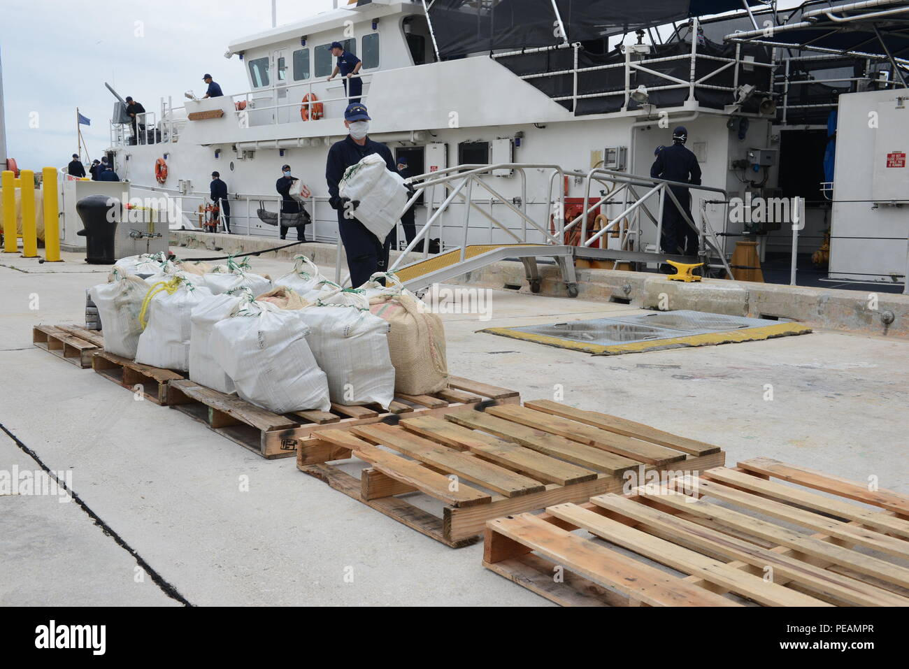 Coast Guardsmen aboard the Coast Guard Cutter Webber offload cocaine at Coast Guard Sector Miami Beach, Fla., Nov. 20, 2015. The HNLMS Friesland, an offshore patrol vessel from the Royal Netherlands Navy, interdicted a go-fast vessel with four suspected smugglers and 22 bales of cocaine with an estimated wholesale value of $17 million. (U.S. Coast Guard photo by Petty Officer 2nd Class Mark Barney) Stock Photo