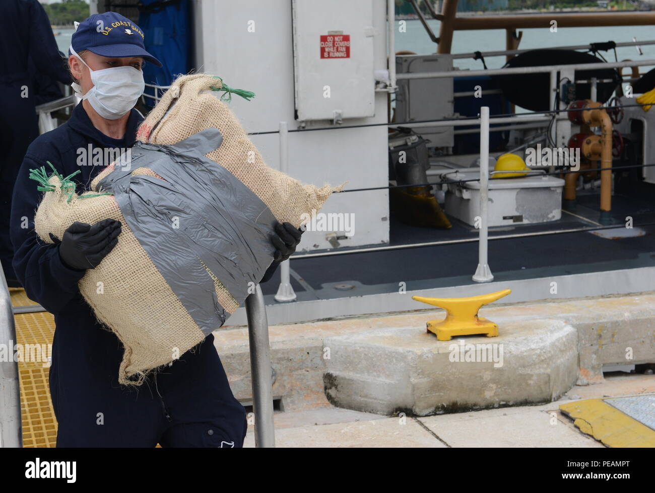 A Coast Guardsman offloads cocaine at Coast Guard Sector Miami Beach, Fla., Nov. 20, 2015. The HNLMS Friesland, an offshore patrol vessel from the Royal Netherlands Navy, interdicted a go-fast vessel with four suspected smugglers and 22 bales of cocaine with an estimated wholesale value of $17 million. (U.S. Coast Guard photo by Petty Officer 2nd Class Mark Barney) Stock Photo