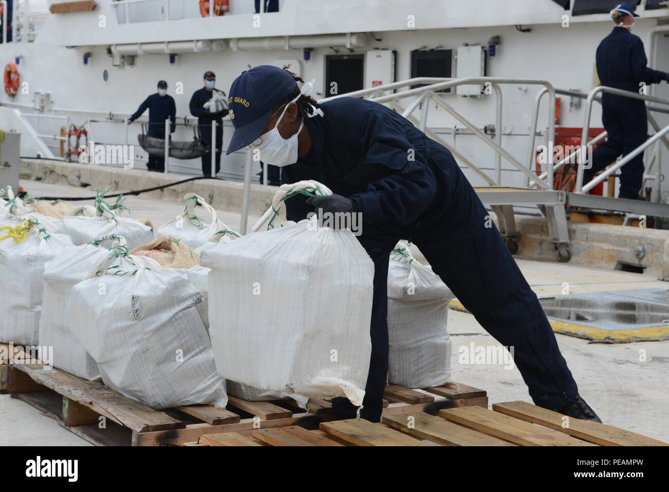 A Coast Guardsman offloads cocaine at Coast Guard Sector Miami Beach, Florida, Nov. 20, 2015. The HNLMS Friesland, an offshore patrol vessel from the Royal Netherlands Navy, interdicted a go-fast vessel with four suspected smugglers and 22 bales of cocaine with an estimated wholesale value of $17 million. U.S. Coast Guard photo by Petty Officer 2nd Class Mark Barney. Stock Photo