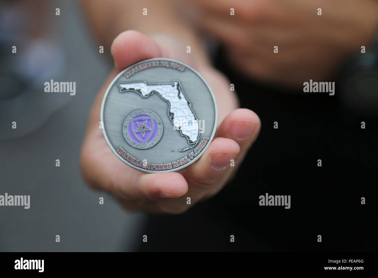 A unit coins is given to members of the US Army Reserve 4th Joint Communication Squadron (4JCS) Mustang Team before the relay race begins for the 35th Annual Mattar Relay held annually, MacDill Air Force Base, Tampa, Fla., Nov. 20, 2015. U.S. Lt. Col. George Mattar, a Citadel alumni and former Joint Communications Support Element (JCSE) commander, was killed on Jan. 13, 1982, when his flight, Florida Airlines No. 90, crashed into the waters of the Potomac River. Aboard this flight were 74 passengers, of which only six survived. Also killed were Maj. Ralph Herman, JCSE's Chief of Operations, an Stock Photo