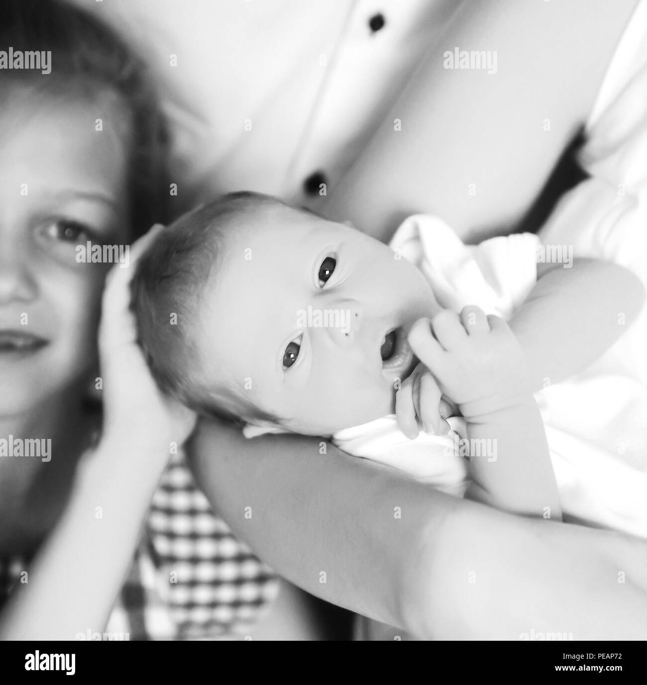 older sister next to a newborn baby Stock Photo
