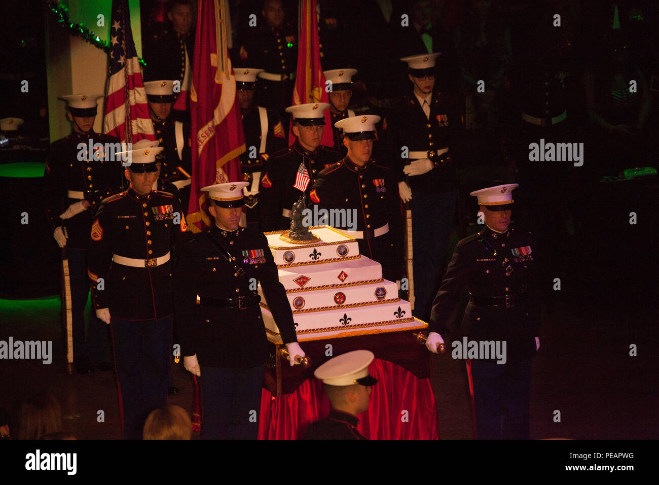 U.S. Marines with the Marine Forces Reserve and Marine Forces North, escort the birthday cake into position during the celebration of the 240th Marine Corps Birthday Ball at Mardi Gras World, New Orleans, La., Nov. 21, 2015. This year’s celebration honors those past, present, and future Marines throughout history and marks the 240th Marine Corps Birthday since its founding on Nov. 10, 1775. (U.S. Marine Corps photo by Kimberly Aguirre/Released) Stock Photo