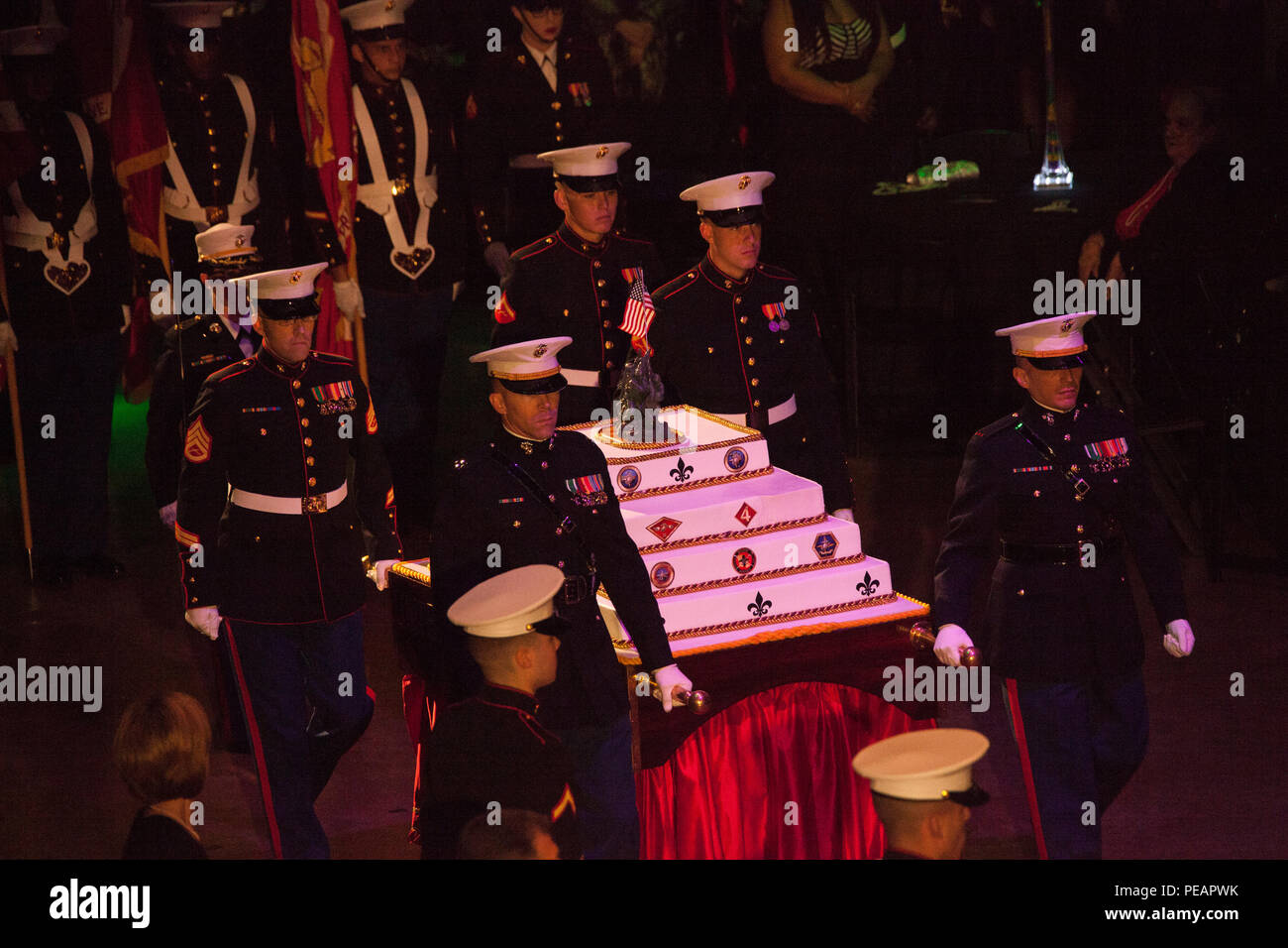 U.S. Marines with the Marine Forces Reserve and Marine Forces North, escort the birthday cake into position during the celebration of the 240th Marine Corps Birthday Ball at Mardi Gras World, New Orleans, La., Nov. 21, 2015. This year’s celebration honors those past, present, and future Marines throughout history and marks the 240th Marine Corps Birthday since its founding on Nov. 10, 1775. (U.S. Marine Corps photo by Kimberly Aguirre/Released) Stock Photo