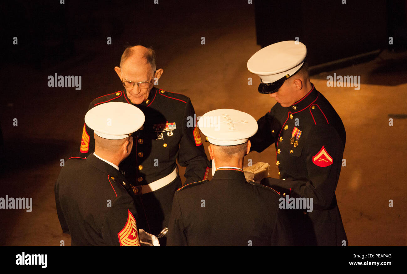 U.S. Marine Lt. Gen. Rex C. McMillian, Commander of Marine Forces Reserve and Marine Forces North, hands the first piece of cake to the oldest Marine in attendance, U.S. Marine GySgt. (Retired) Robert L. Allen, Infantryman, during the celebration of the 240th Marine Corps Birthday Ball at Mardi Gras World, New Orleans, La., Nov. 21, 2015. This year’s celebration honors those past, present, and future Marines throughout history and marks the 240th Marine Corps Birthday since its founding on Nov. 10, 1775. (U.S. Marine Corps photo by Kimberly Aguirre/Released) Stock Photo