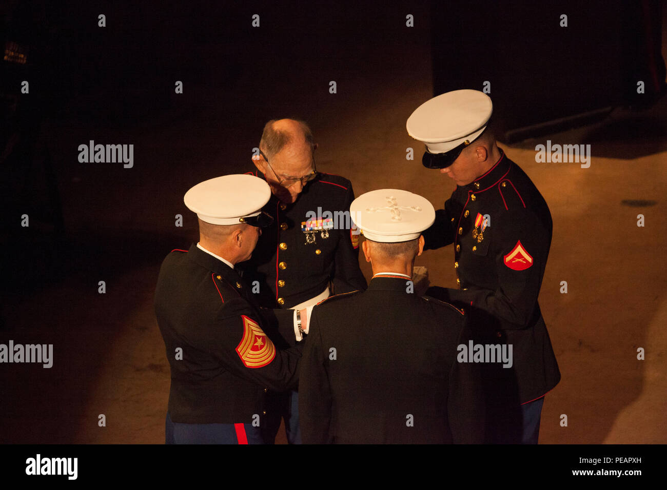 U.S. Marine Lt. Gen. Rex C. McMillian, Commander of Marine Forces Reserve and Marine Forces North, hands the first piece of cake to the oldest Marine in attendance, U.S. Marine GySgt. (Retired) Robert L. Allen, Infantryman, during the celebration of the 240th Marine Corps Birthday Ball at Mardi Gras World, New Orleans, La., Nov. 21, 2015. This year’s celebration honors those past, present, and future Marines throughout history and marks the 240th Marine Corps Birthday since its founding on Nov. 10, 1775. (U.S. Marine Corps photo by Kimberly Aguirre/Released) Stock Photo