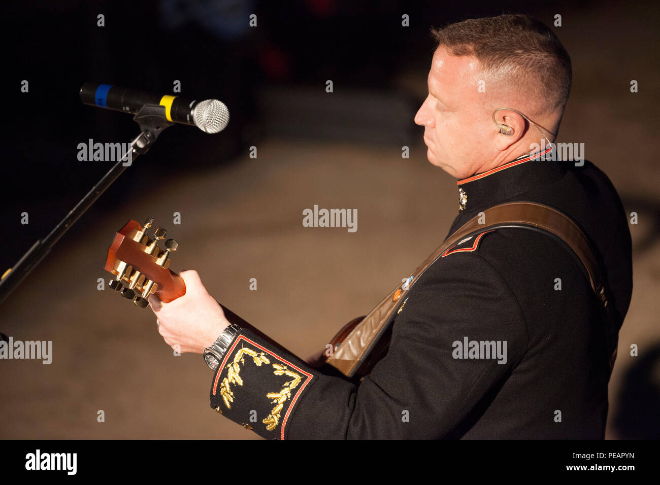 U.S. Marine Lt. Col. Michael Corrado, Deputy Assistant Chief of Staff G-3, 4th Marine Division, Marine Forces Reserve, performs his song “Stand” during the celebration of the 240th Marine Corps Birthday Ball at Mardi Gras World, New Orleans, La., Nov. 21, 2015. This year’s celebration honors those past, present, and future Marines throughout history and marks the 240th Marine Corps Birthday since its founding on Nov. 10, 1775. (U.S. Marine Corps photo by Kimberly Aguirre/Released) Stock Photo
