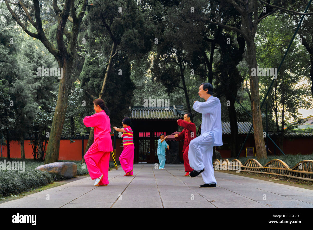 5 People doing Morning Exercise, Tai Chi in front of a Chinese temple Stock Photo