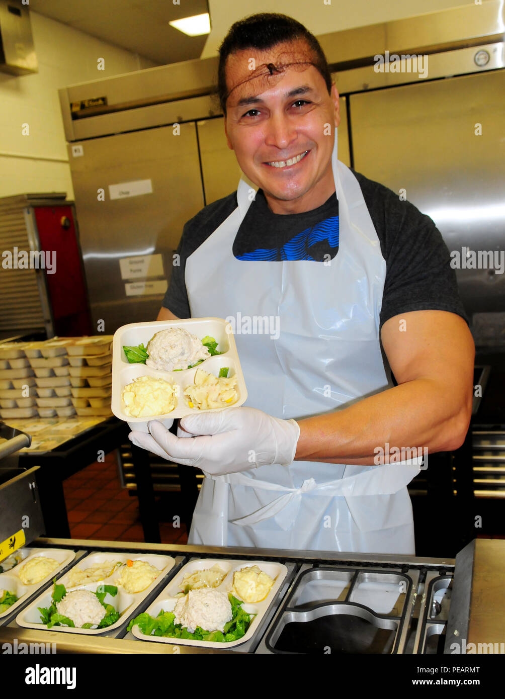 Master Sgt. Roy Garza, 149th Operations Group member, shows off a prepackaged microwavesafe