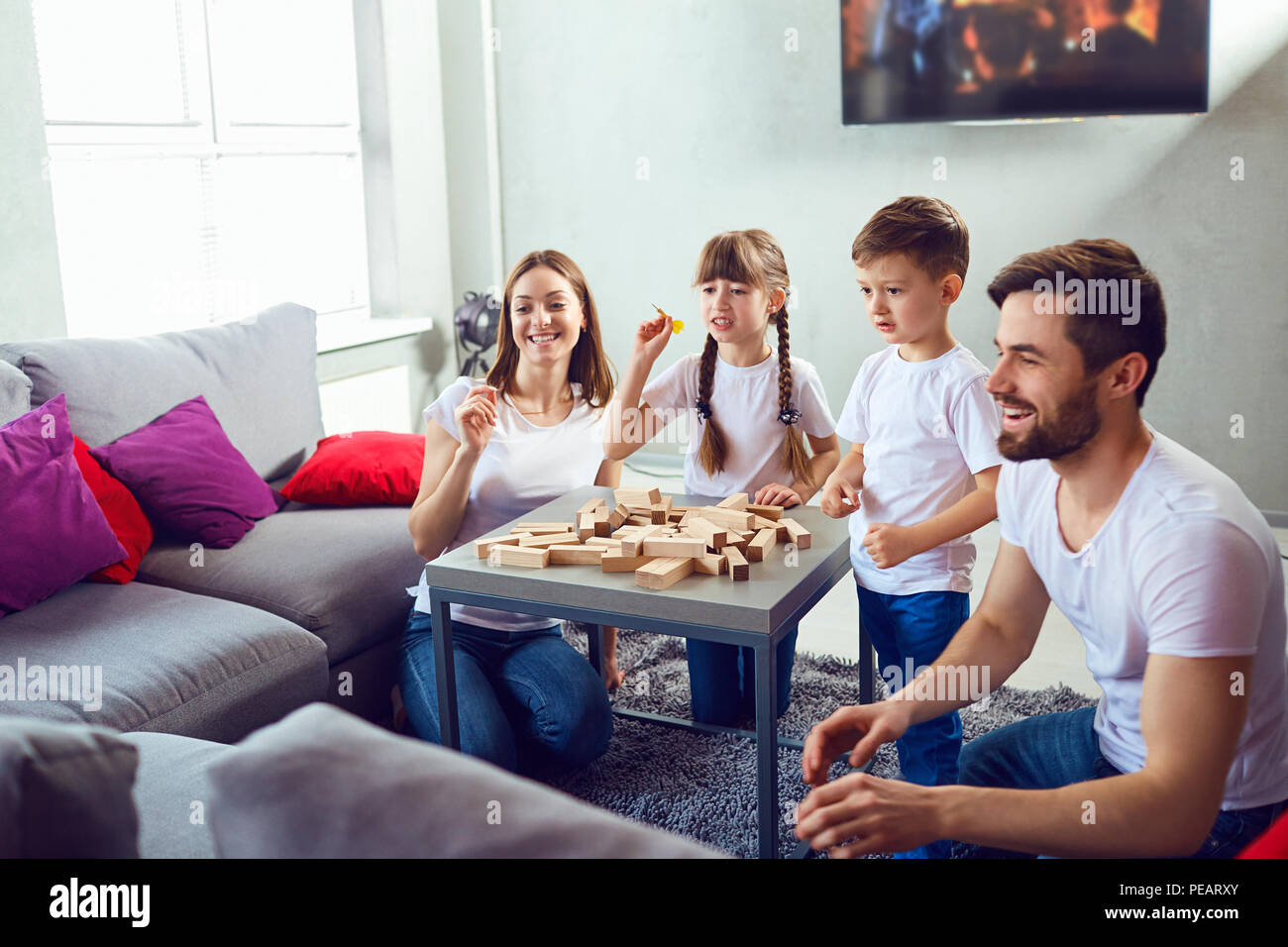 Mother, father and children play together. Stock Photo