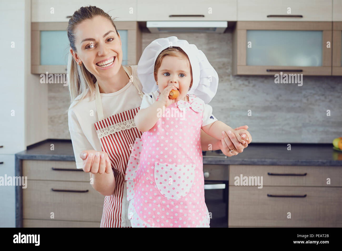 Mom with baby in the kitchen hires stock photography and images Alamy