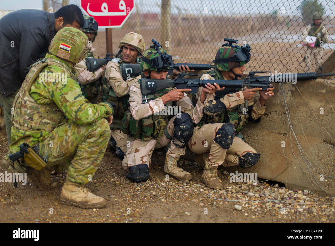 An Australian Soldier With Task Group Taji Advises A Team Of Iraqi Soldiers Assigned To The 71st Iraqi Army Brigade On Reacting To Enemy Fire During A Simulated Exercise Under Fire While