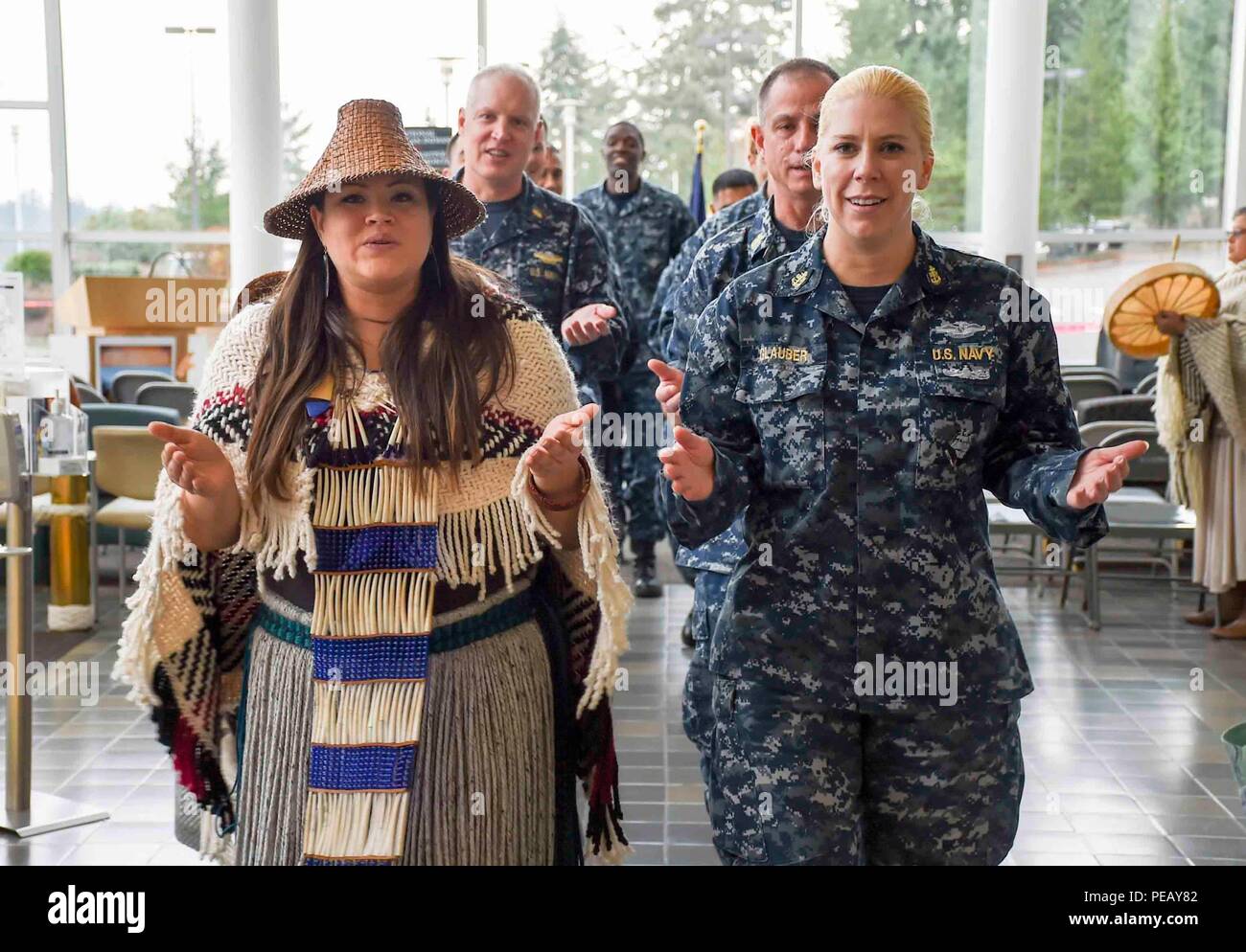 Naval Hospital Bremerton (Nov. 23, 2015) Staff members perform a traditional tribal dance at Naval Hospital Bremerton for a Native American Heritage Ceremony in honor of Native American Heritage Month. (U.S. Navy photo by Mass Communication Specialist 3rd Class Shauna C. Sowersby/Released) Stock Photo
