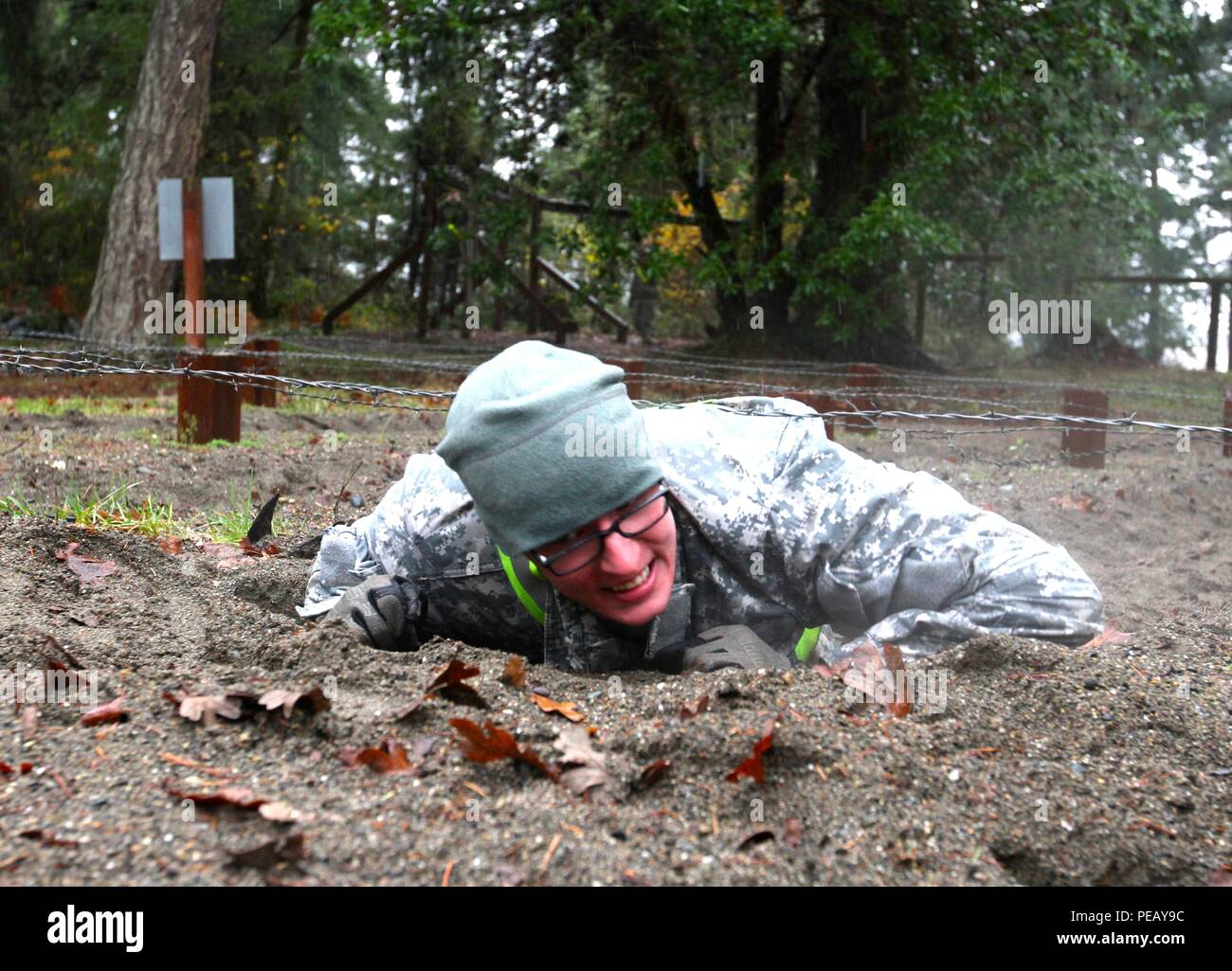 Sgt. Tyler Koon, command post node team chief, 51st Signal Battalion Expeditionary, begins the low crawl obstacle during the Rest Assured Challenge IV competition on Joint Base Lewis-McChord, Wash., Nov. 24. The Rest Assured Challenge is a quarterly competition designed to instill physical and mental toughness in 593rd Soldiers. Stock Photo