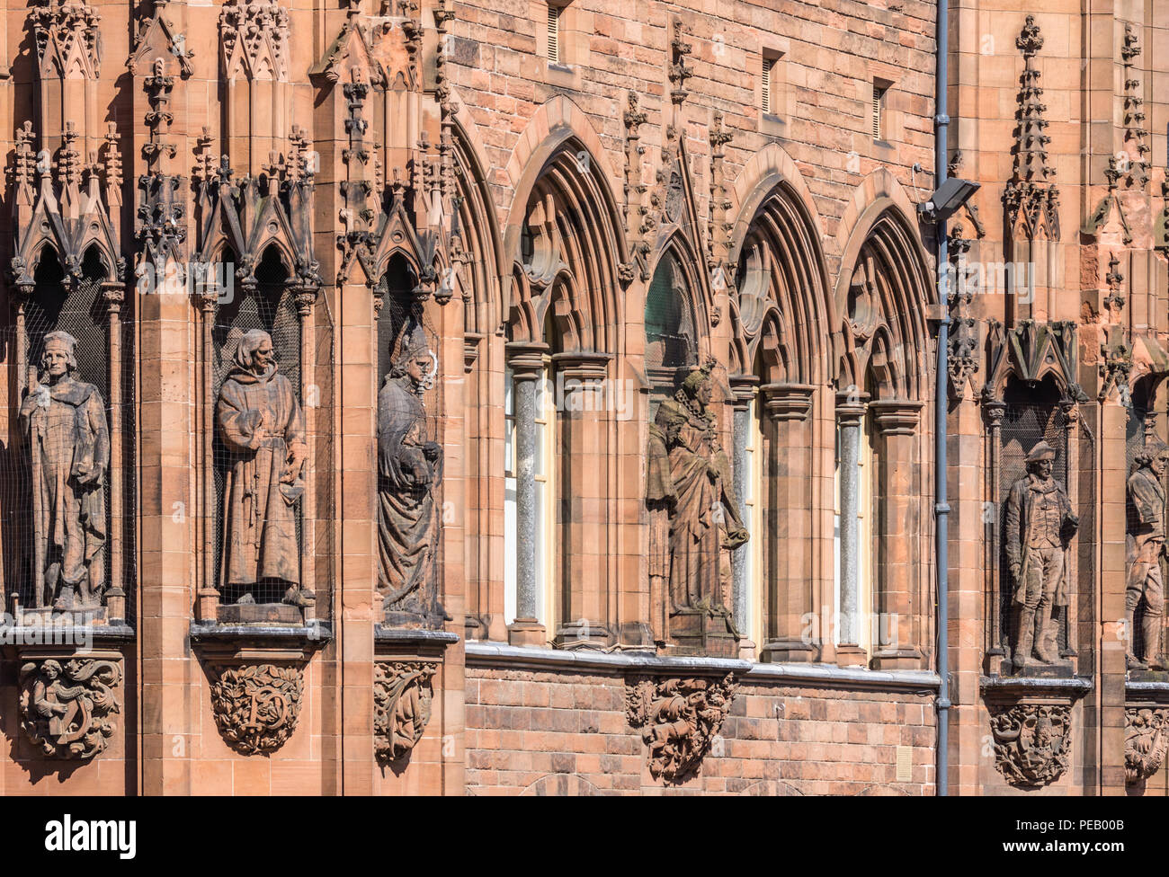 Edinburgh, Scotland, UK - June 13, 2012: Closeup of Row of statues of historic individuals on facade in brown stone of Scottish National Portrait Gall Stock Photo