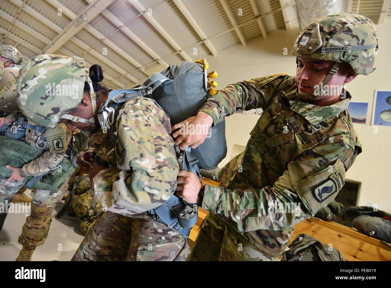 U.S. Army Sgt. Alonso E. Rodriguez, a paratrooper assigned to the 54th  Brigade Engineer Battalion, 173rd Airborne Brigade, inspects 1st Lt.  Natalia S. Bailey's equipment before an airborne operation at Aviano Air
