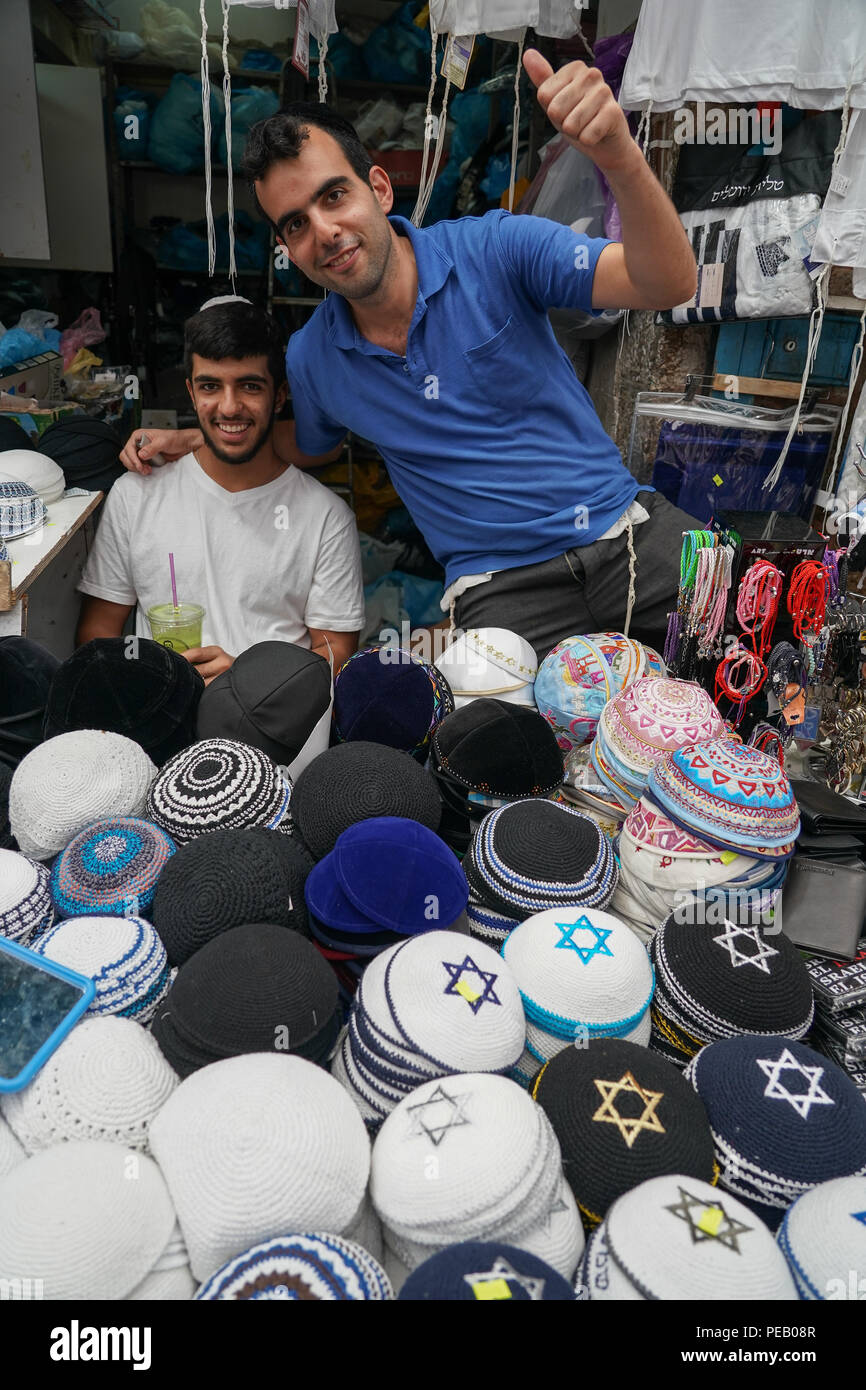 Two sellers of traditional Jewish kippahs (also called a kappel or skull cap) on a market stall in Machane Yehuda market in Jewish west Jerusalem. Fro Stock Photo