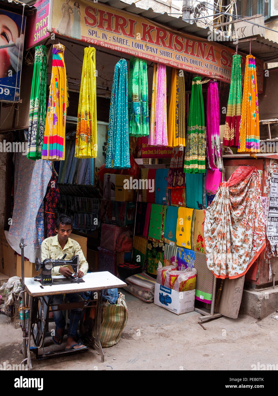 Young man working on his sewing machine at Sangatrashan Bazar, New Delhi, India Stock Photo