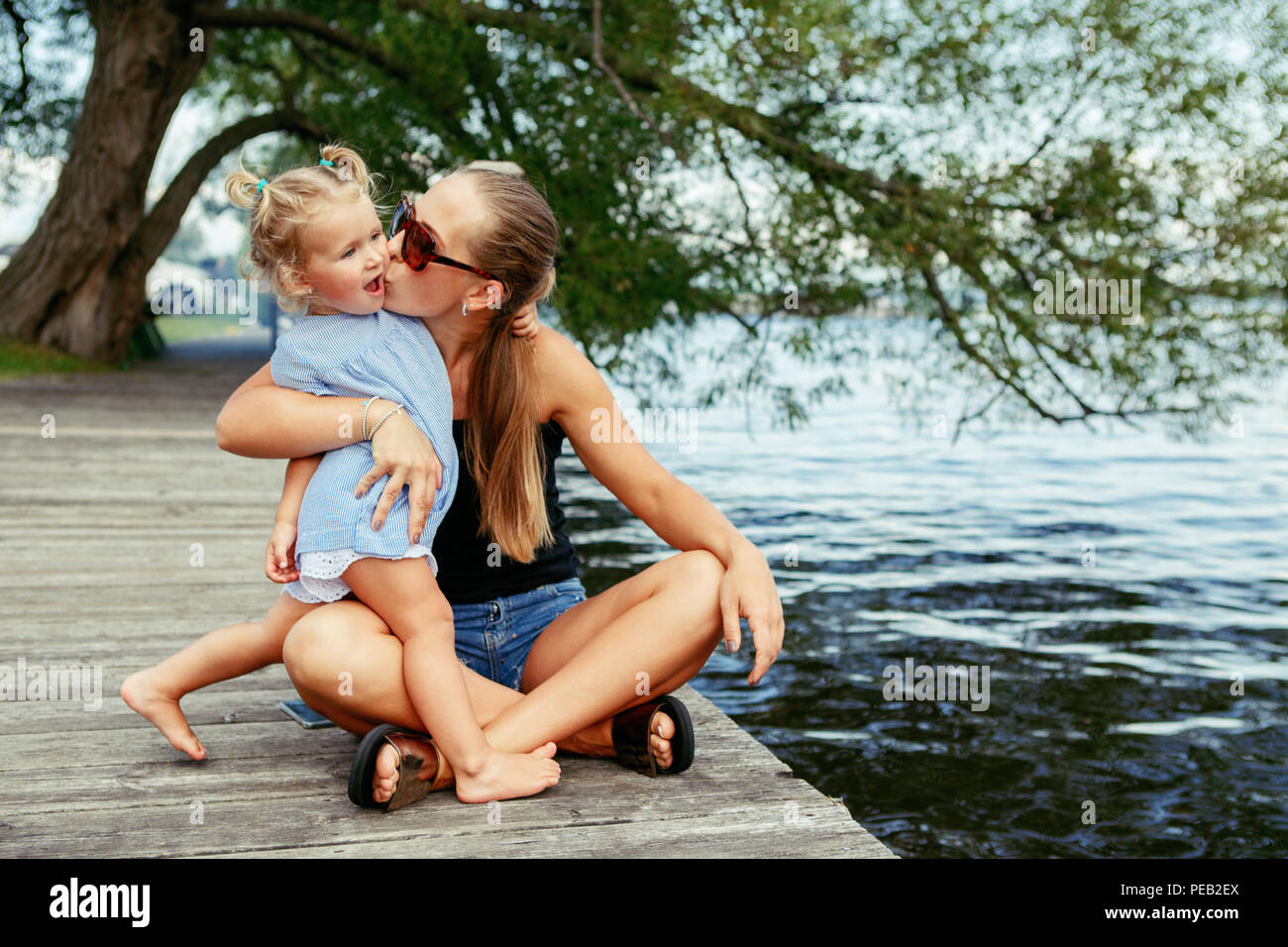 Group portrait of happy white Caucasian mother and daughter child having fu...