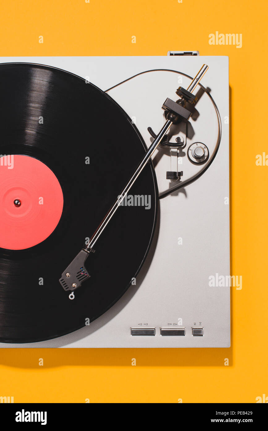 top view of retro vinyl player and record isolated on yellow Stock Photo
