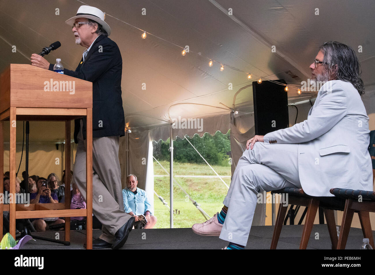 Peterborough, NH (US). 12 April, 2018. Graphic novelist Art Spiegelman, left, the MacDowell Colony's 2018 recipient of the Edward MacDowell Medal, speaks during the award presentation ceremony at the colony in Peterborough, NH (US) while Michael Chabon, the colony's board chairman, listens. Spiegelman, author of the Pulitzer Prize winning graphic novel 'Maus', received the award 'for his contributions to comic art and American culture'. Mike Plotczyk/Alamy Live News Stock Photo