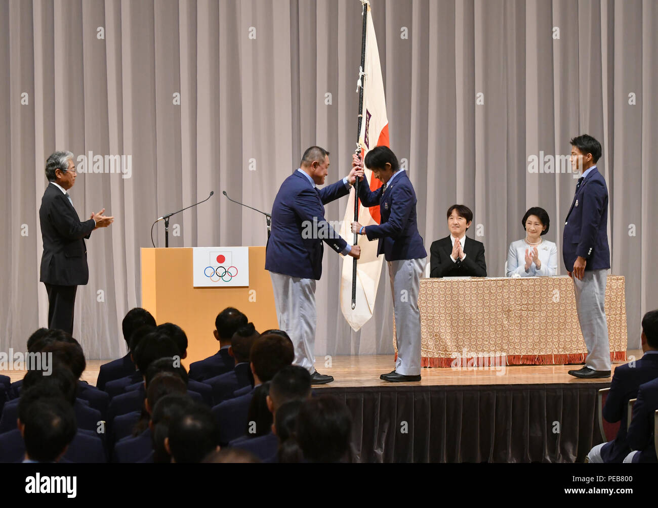 Tokyo, Japan. 13th Aug, 2018. A Japanese flag is presented to Yukiko Ueno, right, the flag
