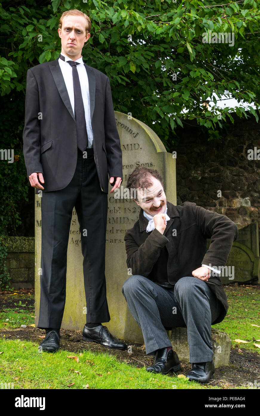 Edinburgh, Scotland, UK. 14th August 2018. Edinburgh Fringe Festival Canongate churchyard, Edinburgh, Scotland, United Kingdom. Winners of Show of the Week Award at VAULT Festival 2018, Dominic Allen and Simon Maeder present Providence, a dark comedy about the life and works of America’s horror writer, HP Lovecraft by Turnpike Productions. Simon Maeder plays HP Lovecraft and Dominic Allen plays Edgar Allan Poe Stock Photo