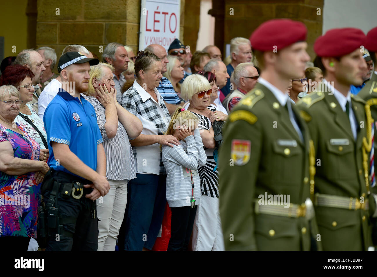 Chomutov, Czech Republic. 14th Aug 2018. A crowd of about 300 gathered before the Saint Ignatius of Loyla Church at the namesti 1. maje square in Chomutov at the beginning of the funeral of Martin Marcin, one of the three Czech soldiers who died in a suicide bomb attack in Afghanistan on August 5, today, on Tuesday, August 14, 2018. There were Marcin's friends, relatives and other soldiers, many of whom bringing flowers or lighting up candles at the commemorative site outside the church. Credit: CTK/Alamy Live News Stock Photo