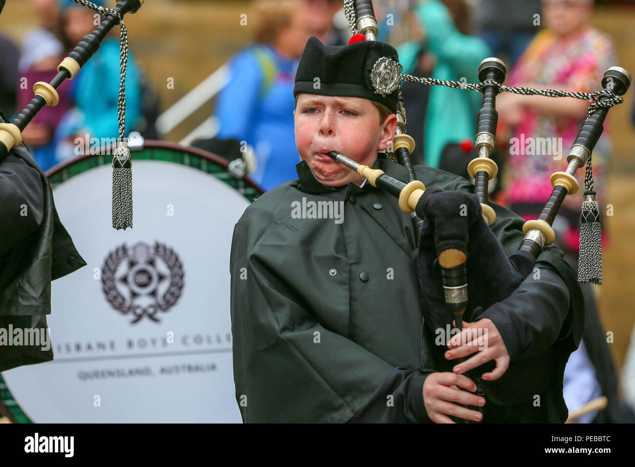Glasgow, UK. 14th Aug 2018. Rain didn't stop play for the Brisbane Boys College Pipe Band from Australia who entertained the public by playing in rain showers in Buchanan Street, Glasgow. The World Pipe Band Championships are on Saturday 18 August with Pipe bands from around the world competing for the title. Liam Docherty from Brisbane is one of the pipers Credit: Findlay/Alamy Live News Stock Photo