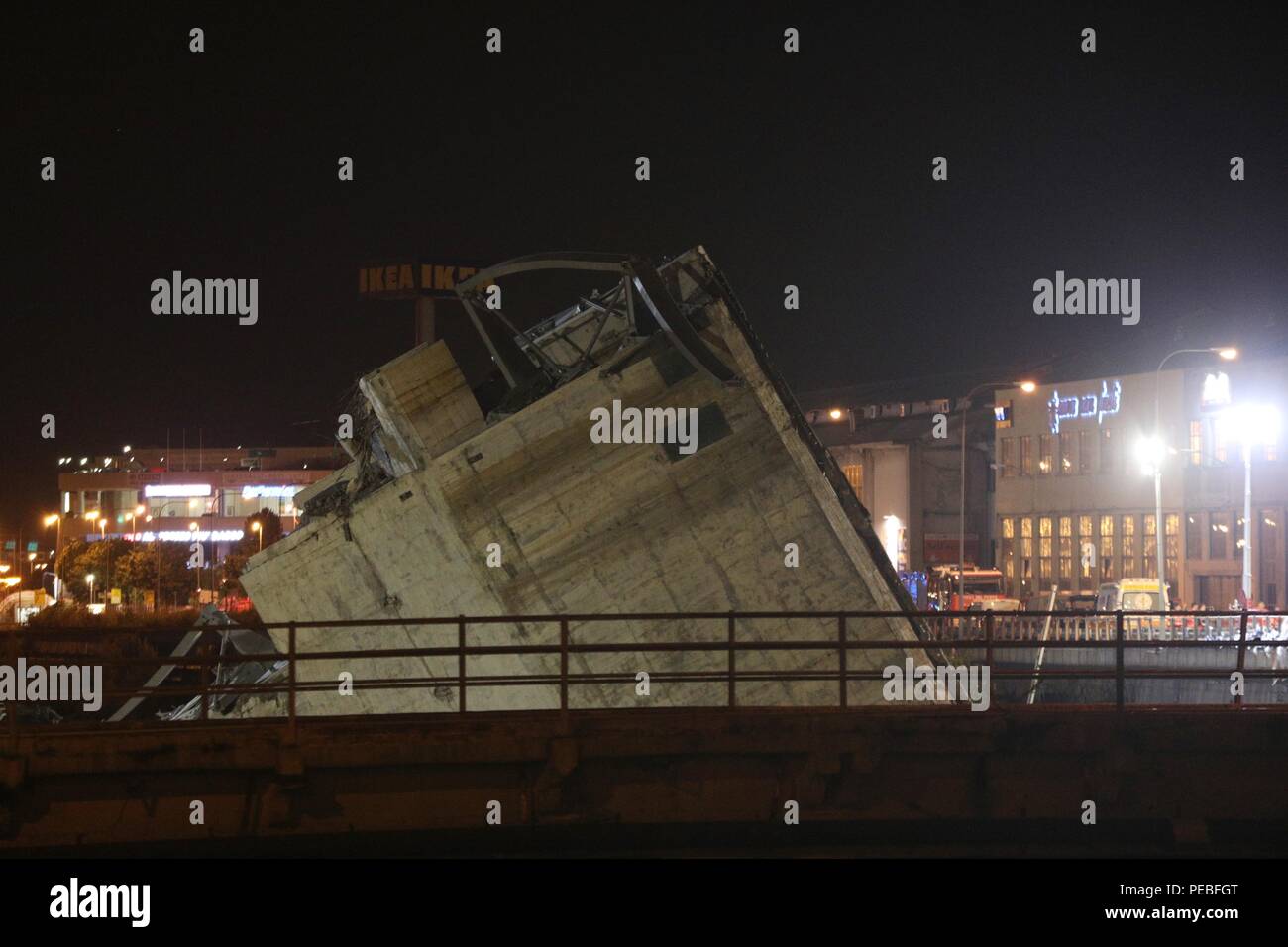 Genoa. 15th Aug, 2018. Part of the collapsed bridge is seen in Italy's northwest city of Genoa, Aug. 15, 2018. The provisional death toll of a bridge collapse in Italy's northwest city of Genoa rose to 26, local authorities said late on Tuesday. Credit: Zheng Huansong/Xinhua/Alamy Live News Stock Photo