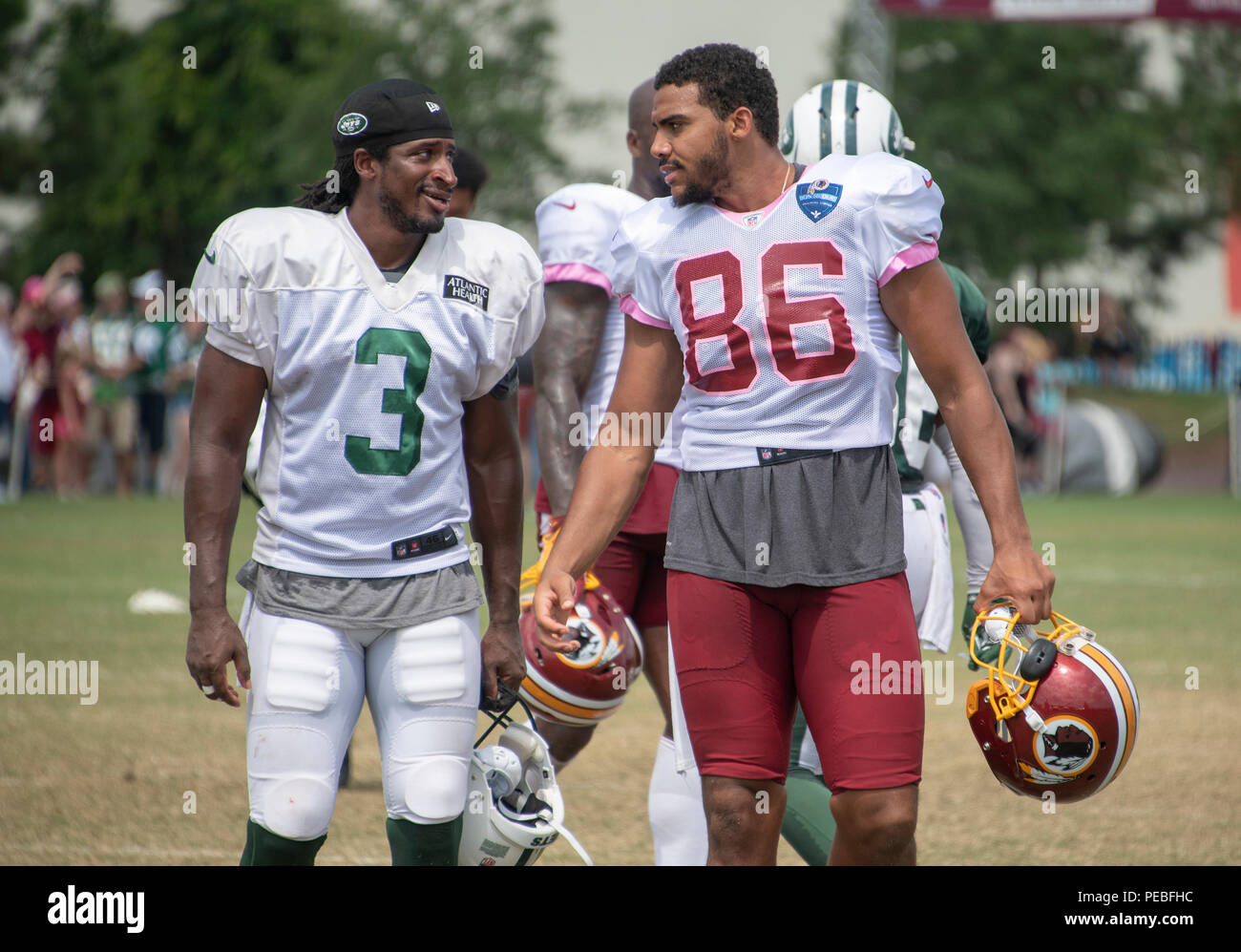 Landover, United States Of America. 13th Aug, 2018. New York Jets wide  receiver Andre Roberts (3) and Washington Redskins tight end Jordan Reed  (86) converse after participating in a joint training camp