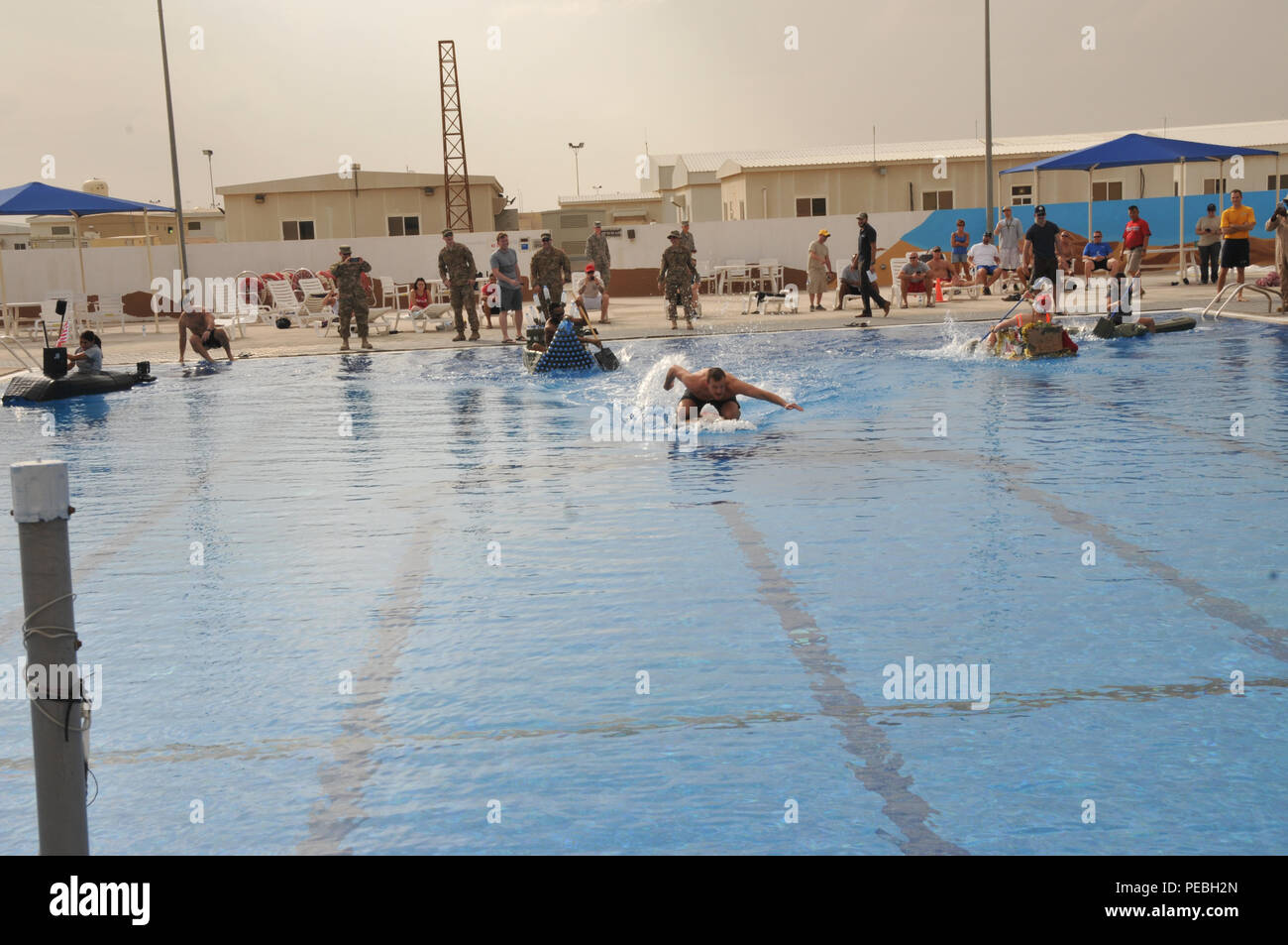 The Thanksgiving pool parade held at Coalition Compound at Al Udeid Air Base,  Qatar, was filled with service members who came out to support their team.  Music and cheers filled the air