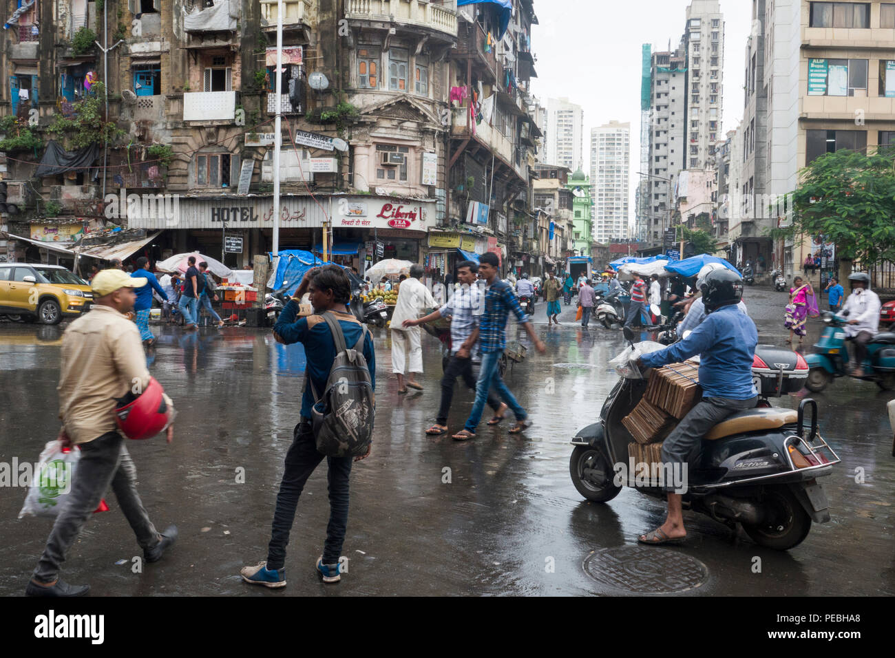 Pedestrians and traffic on street after monsoon downpour in Grant Road, Mumbai, India Stock Photo