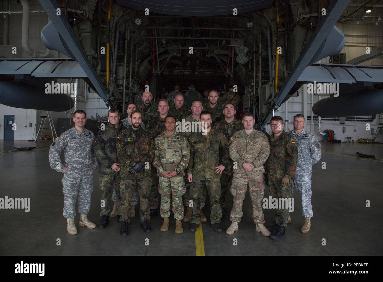 U.S. and German paratroopers pose for a photo after jumpmaster aircraft familiarization training aboard a C-130 Hercules in support of Operation Toy Drop at Simmons Army Air Field, Cumberland County, N.C., Dec. 1, 2015. Operation Toy Drop combines U.S. Army Reserve personnel, Army paratroopers, dozens of volunteers and partner nation military personnel, more than a dozen Air Force aircraft and toys, all for what has become the world’s largest combined airborne operation. (U.S. Army photo by Spc. Tracy McKithern/Released) Stock Photo