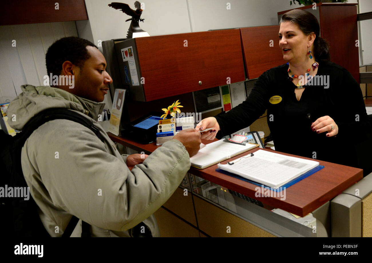 Senior Airman Jaron Liles, 694th Intelligence Support Squadron Criticom technician, speaks with Rebecca Ramirez, 51st Force Support Squadron Airman & Family readiness Center community readiness consultant on Osan Air Base, Republic of Korea, Dec. 2, 2015. The A&FRC here offers a myriad of programs to assist military members and their families with not only the military lifestyle, but also with adjusting to an overseas environment. (U.S. Air Force photo/Senior Airman Kristin High) Stock Photo