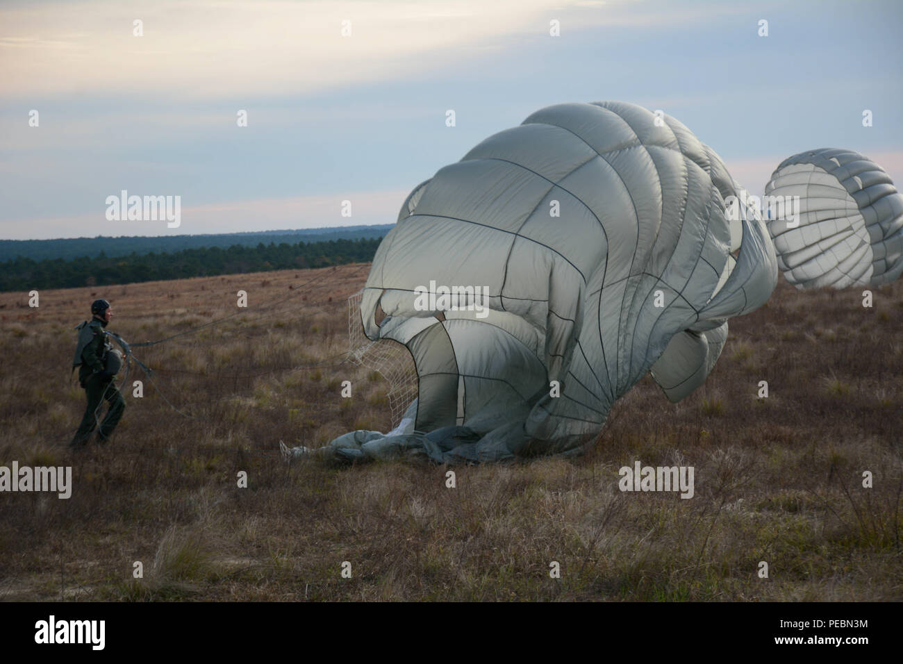 A Dutch paratrooper retrieves his parachute during Operation Toy Drop