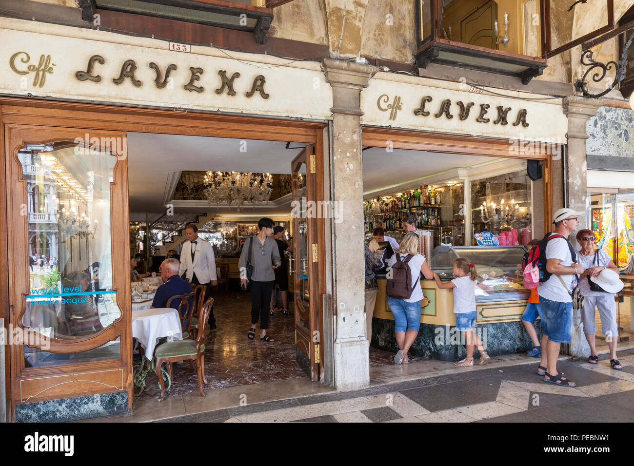 Caffe Lavena, Piazza San Marco, San Marco, Venice, Veneto, Italy. Entrance  and exterior facade with open door view to the bar and eatery. Tourists, cu  Stock Photo - Alamy