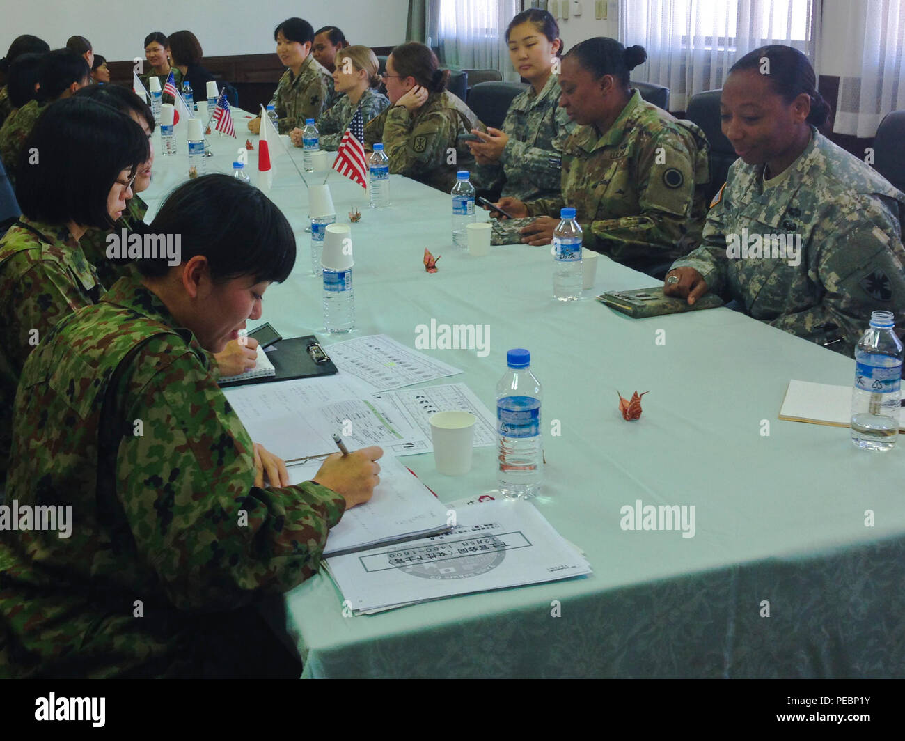 Japanese Service members take notes on some of the differences between
