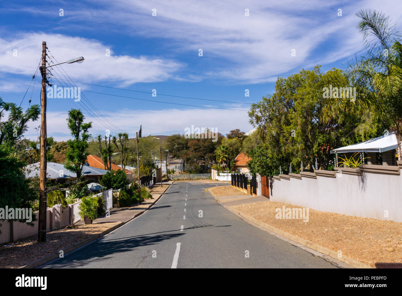 namibia windhoek street sky clouds palm tree Stock Photo