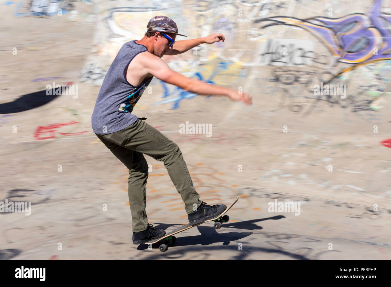 Young Man Skateboarding at the Riverside River Yard Skateboard Bowl, Great Fall, Montana, USA Stock Photo