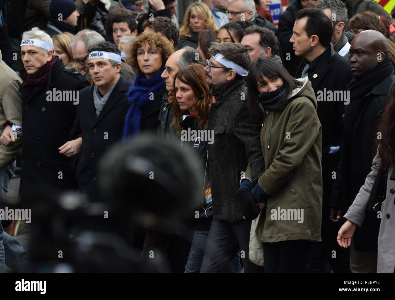 January 11, 2015 - Paris, France:  Family members and close friends of Charlie Hebdo victims, including senior cartoonist Renaud Luzier (known as 'Luz'), attend a mass unity rally following the recent Paris terrorist attacks.  Four million people demonstrated across the country in a 'Marche Republicaine' (Republican March) celebrating the nation's unity in face of terrorist threats. Thousands of people had banners or cartoons referring to Charlie Hebdo, the satirical magazine whose office was targeted by Islamist gunmen earlier in the week.  La grande marche republicaine en hommage aux victime Stock Photo