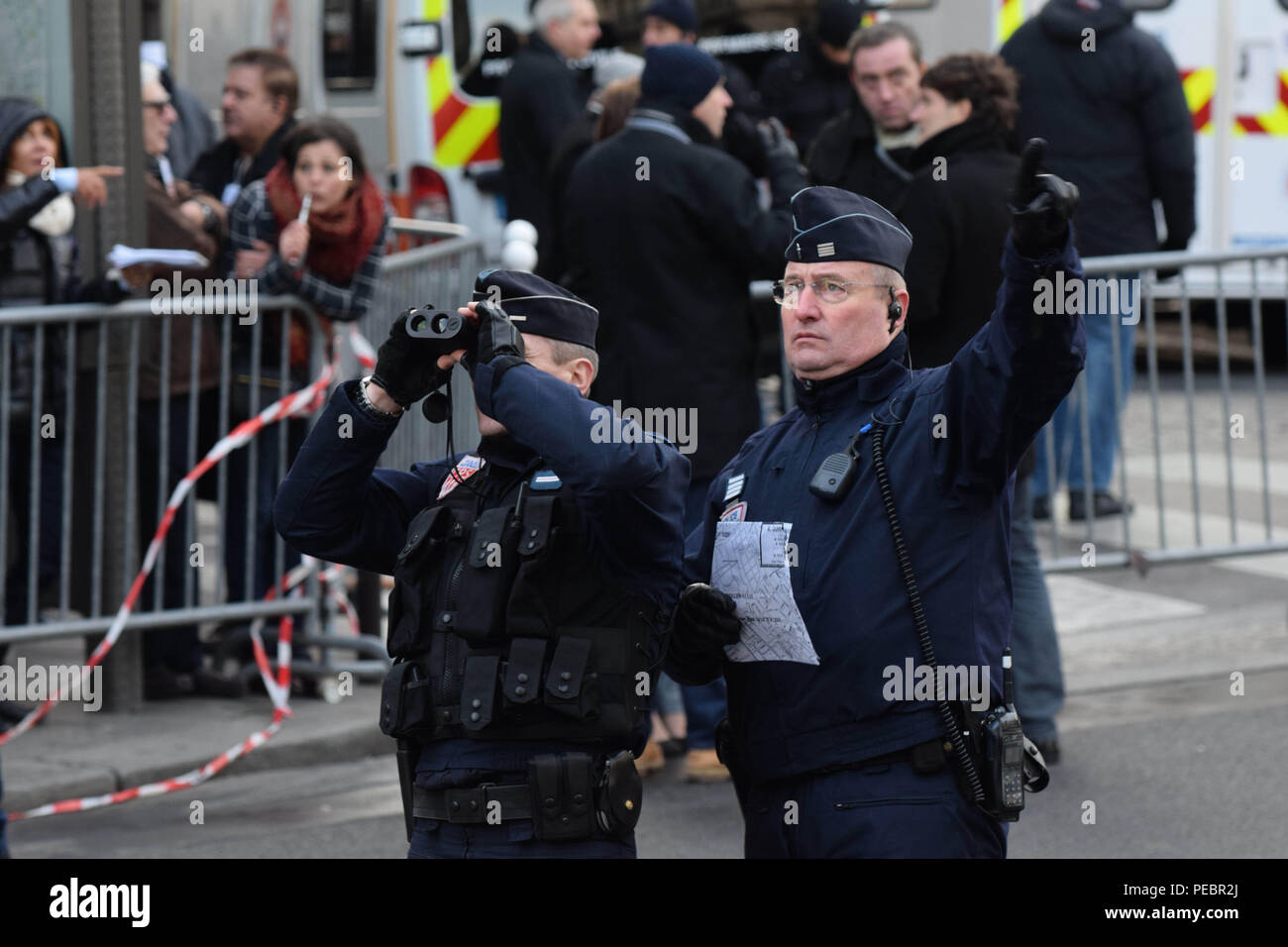 January 11, 2015 - Paris, France:  Police on duty as than 1,5 million people take part in a march to support Freedom of expression and protest against terrorism in the French capital after three days of terror left 17 people dead. Four million people demonstrated across the country in a 'Marche Republicaine' (Republican March) celebrating the nation's unity in face of terrorist threats. Thousands of people had banners or cartoons referring to Charlie Hebdo, the satirical magazine whose office was targeted by Islamist gunmen earlier in the week. La grande marche republicaine en hommage aux vict Stock Photo
