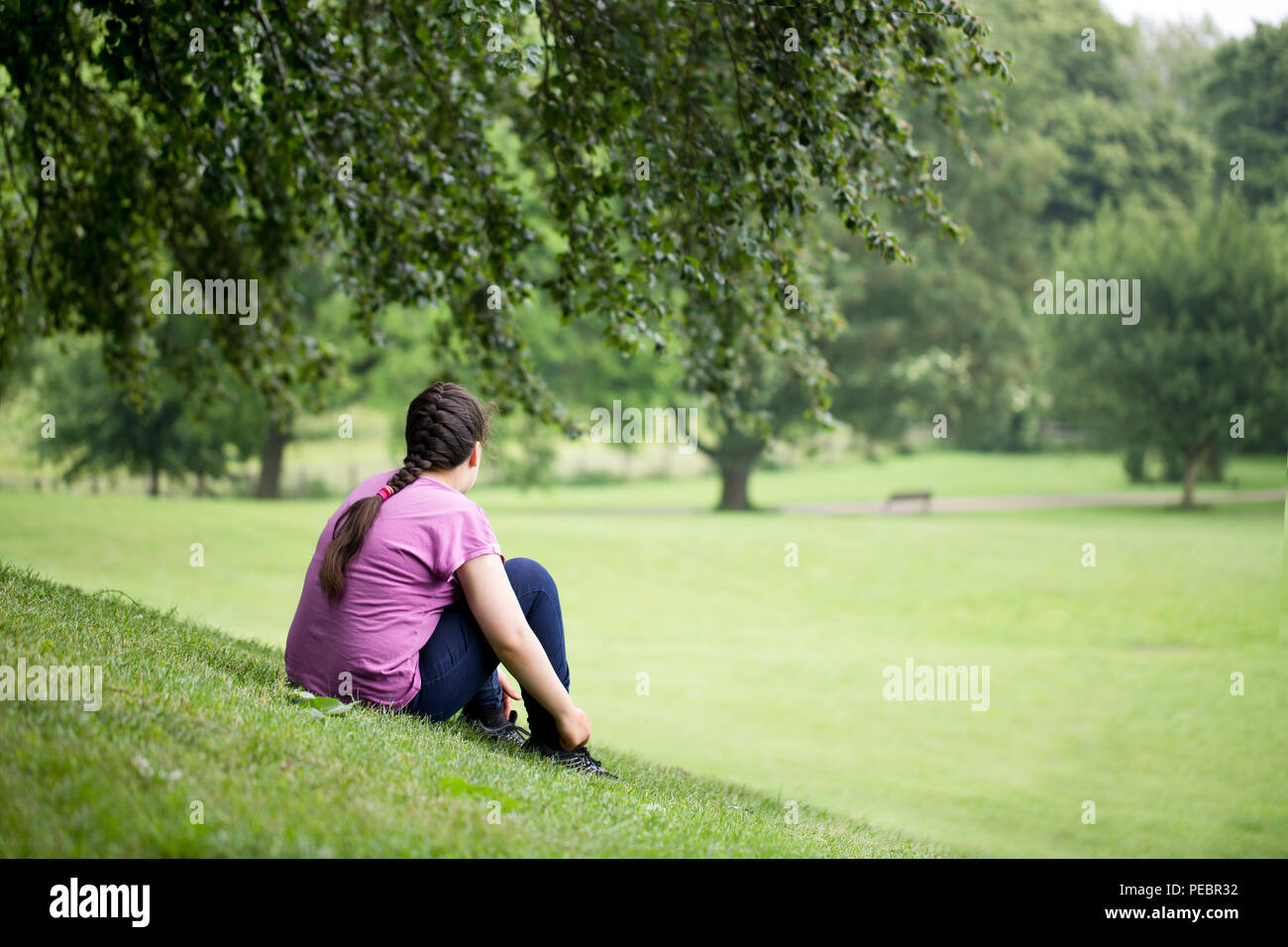Girl sitting on top hill hi-res stock photography and images - Alamy