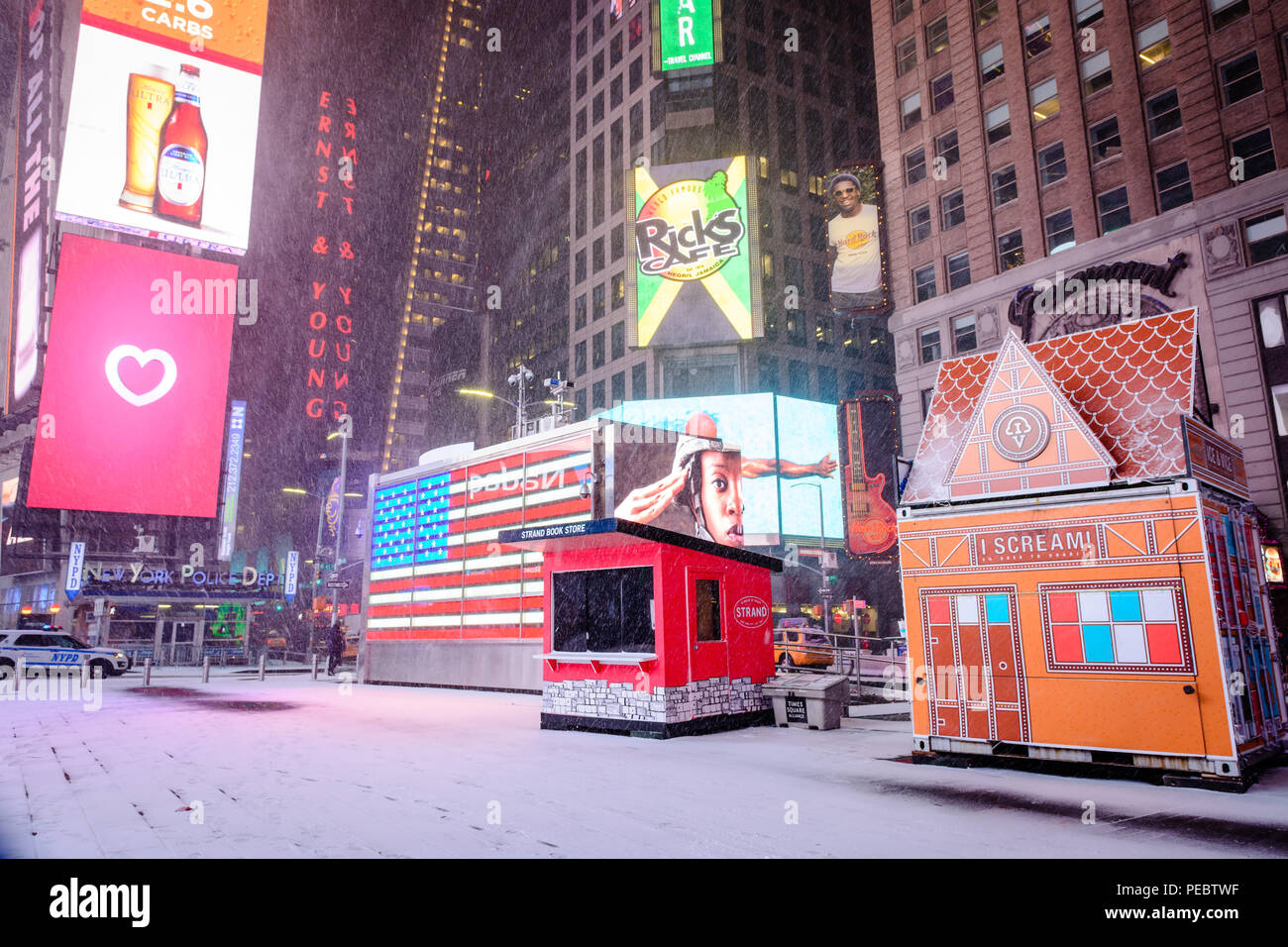 A snow covered sidewalk in Times Square, New York City during Winter Storm Grayson, January 2018. Stock Photo
