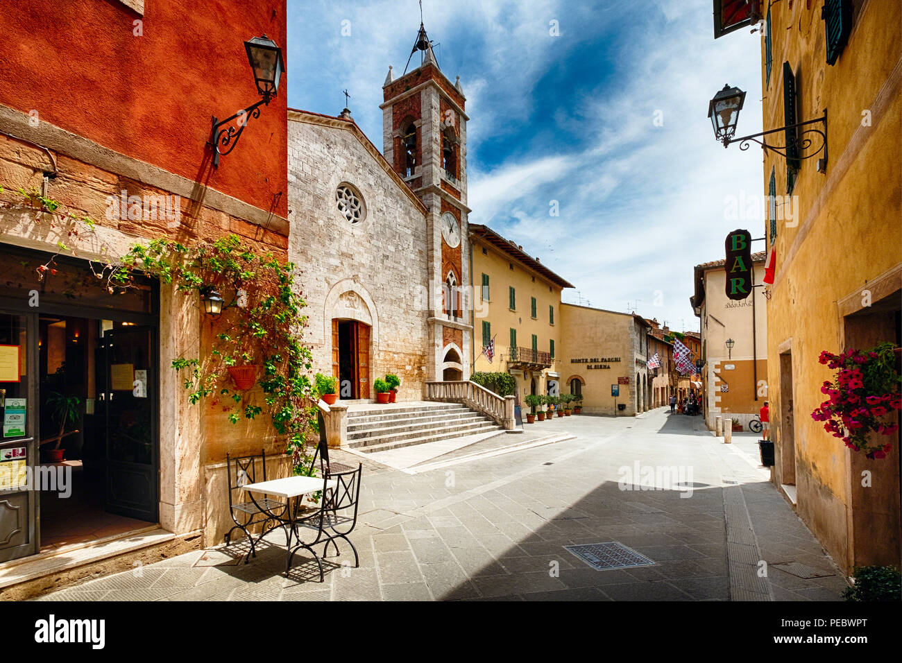 Street with a Catholic Church, San Quirico, Tuscany, Italy Stock Photo