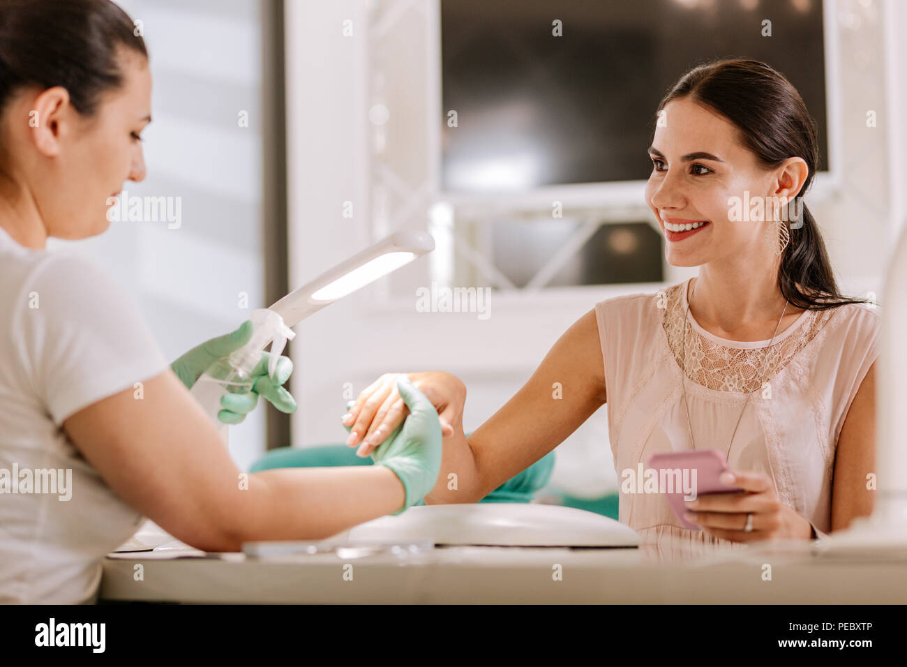 Appealing woman enjoying beauty treatment getting manicure Stock Photo