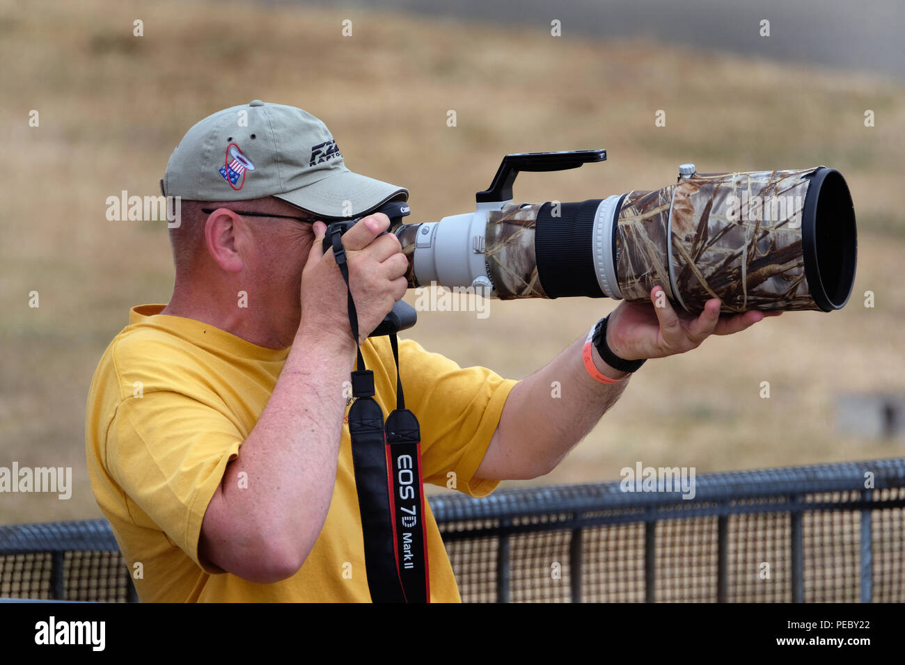Man at air show with long telphoto lens on camera. Stock Photo