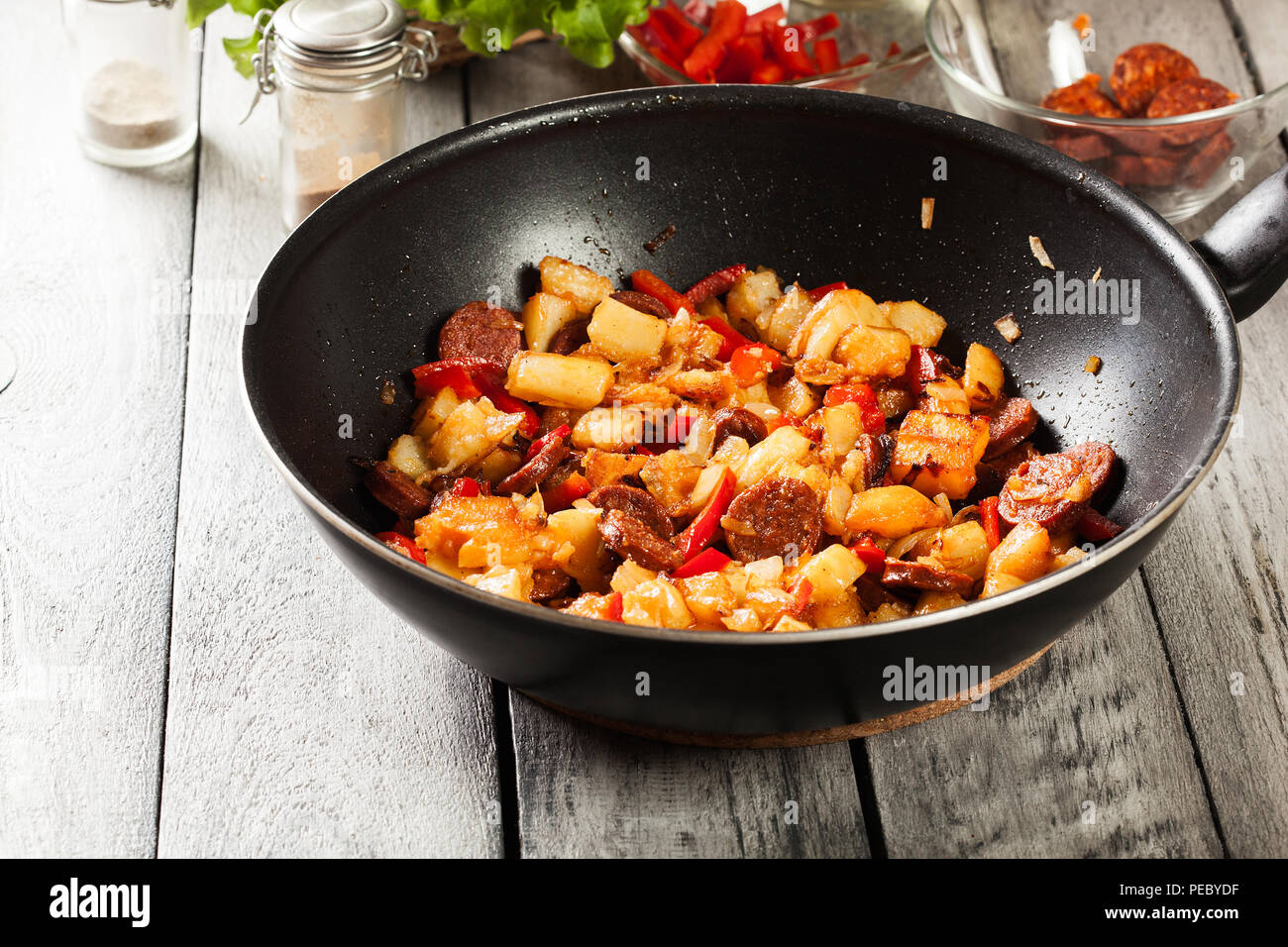 Tortilla de patatas. Cooking spanish omelette with sausage chorizo