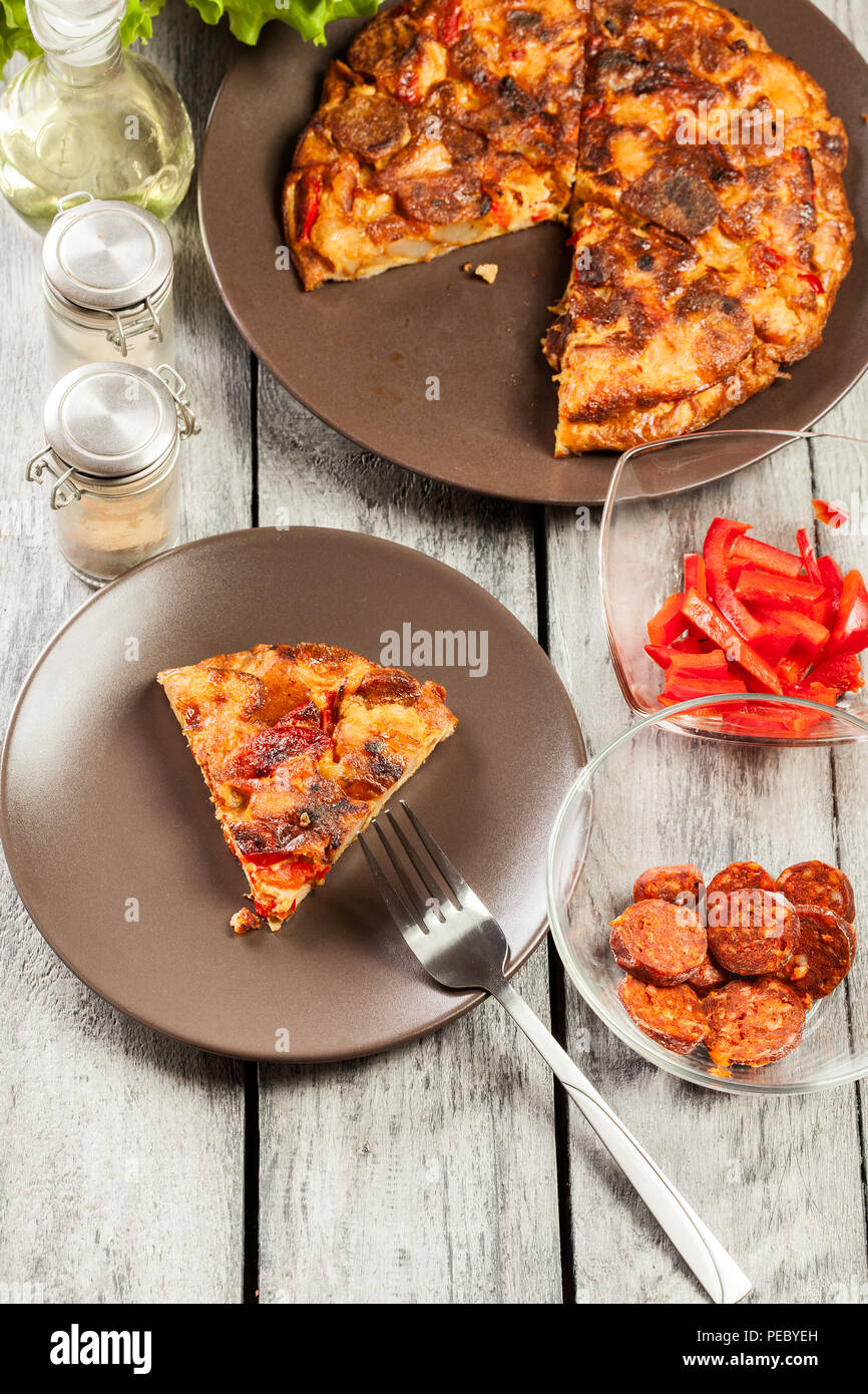 Tortilla de patatas. Spanish omelette with sausage chorizo, potatoes