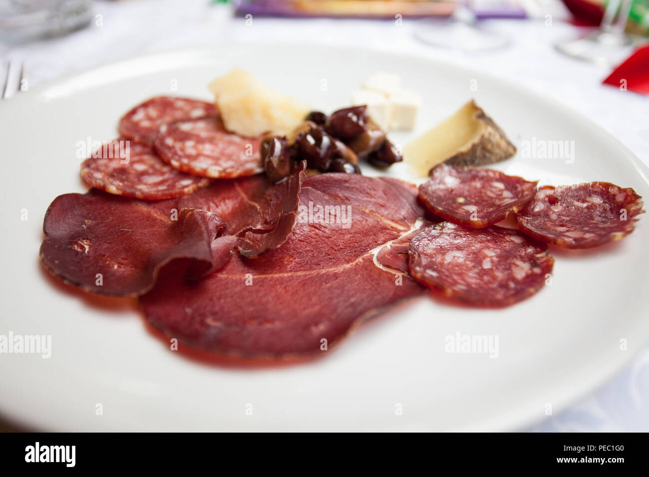 Italian appetizer in a wedding party:deer and wild boar salami, venison ham, seasoned Sardinian pecorino cheese, feta cheese and olives. Stock Photo