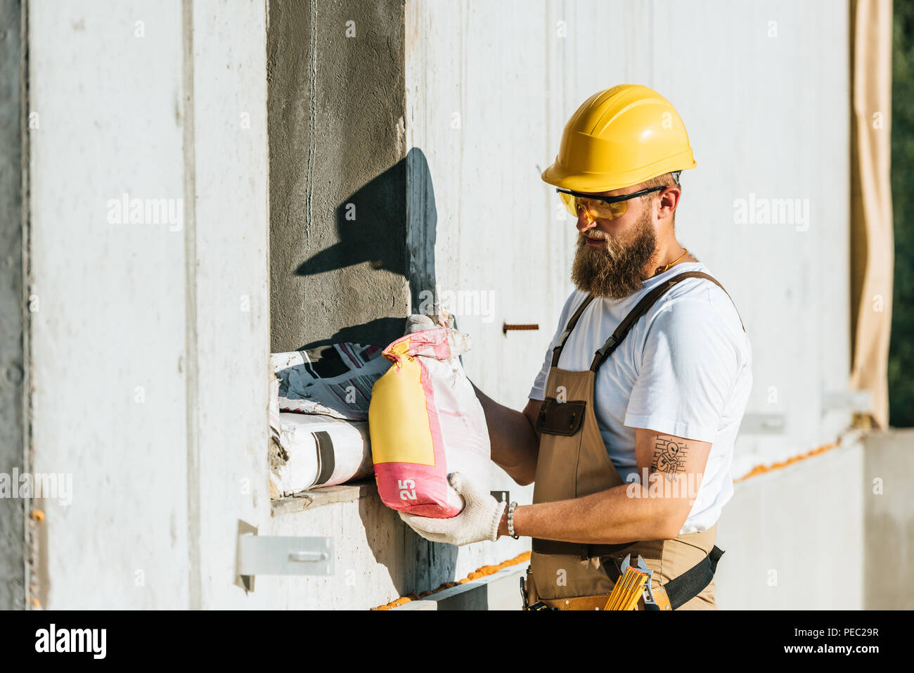Man carrying cement bag hires stock photography and images Alamy